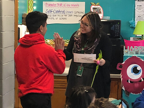 Students high-fiving a teacher