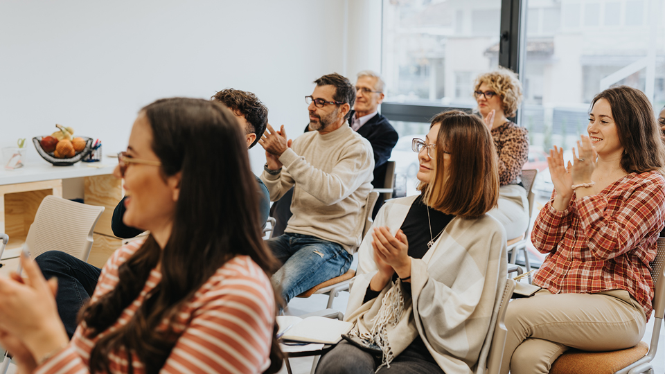 Group of educators applauding a seminar presenter